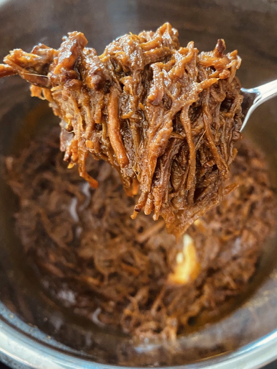 Cooked, tender beef brisket in a rich sauce.