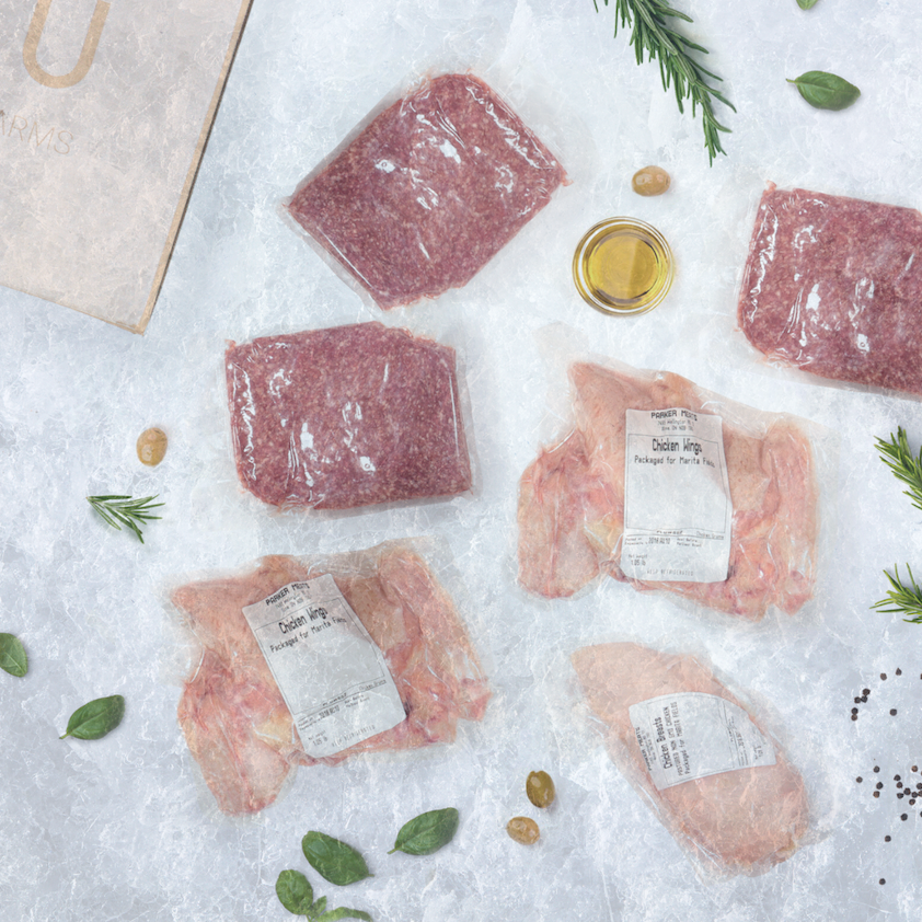 An unboxed NIKU Farms meat subscription box delivery with grass fed beef and pasture raised chicken.