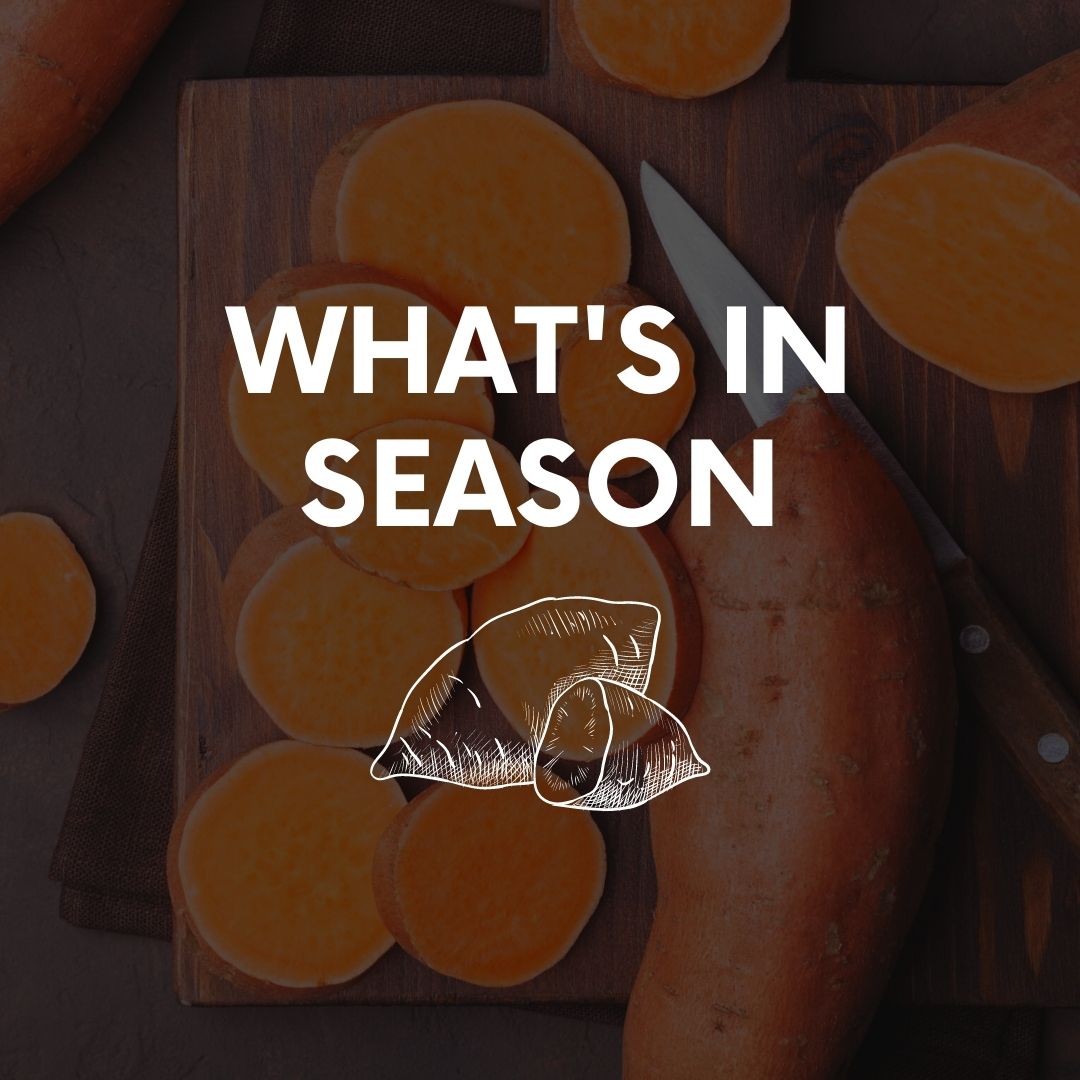 Sweet potatoes on a wooden cutting board, 'what's in season' written over the image.