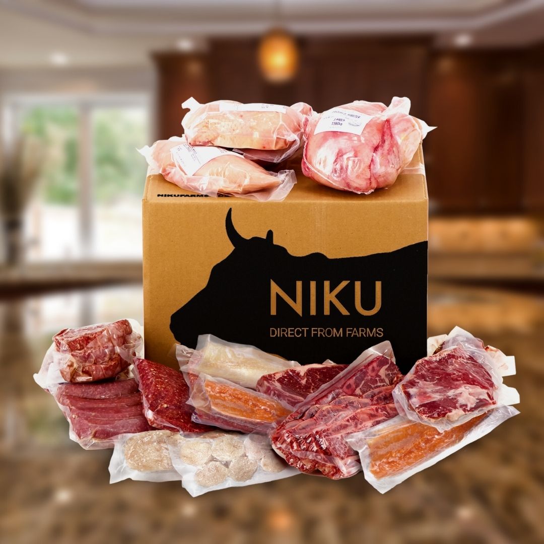 A NIKU Farms box on a countertop surrounded by various types of pasture raised meat and fish.