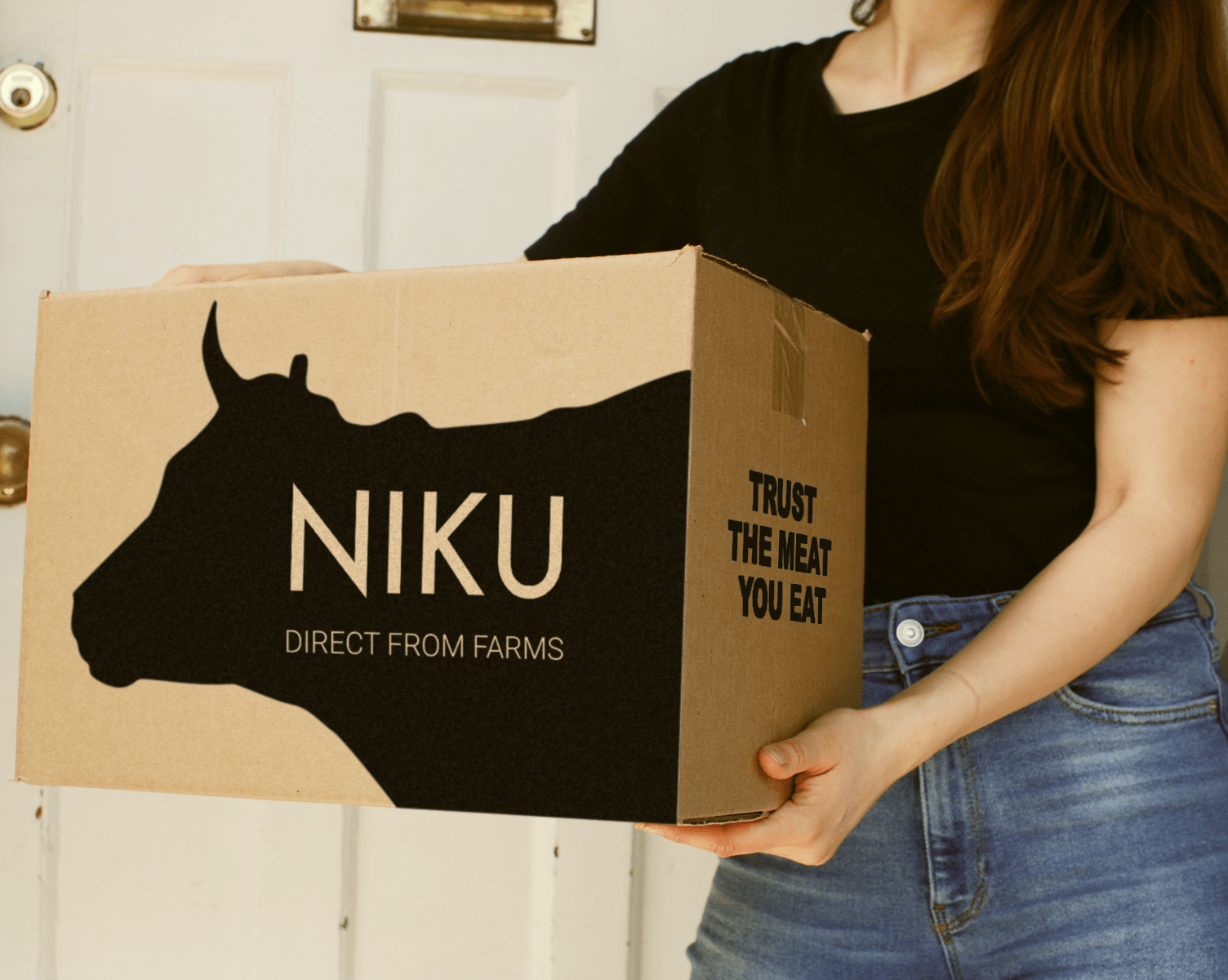 a woman holding a box from Niku Farms