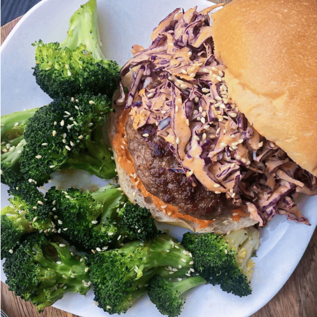 a hamburger served with broccoli